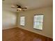 A spacious bedroom features a ceiling fan, wood flooring, and windows at 1204 L Pavia Blvd # 1204, Venice, FL 34292