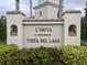 Elegant community sign at L'Pavia Vista Del Lago condominium complex, surrounded by lush landscaping at 1204 L Pavia Blvd # 1204, Venice, FL 34292
