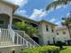 Beautiful condominium building showcasing manicured landscaping, white trim, and a private balcony at 1204 L Pavia Blvd # 1204, Venice, FL 34292