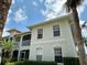 Two story condo showcases well-maintained landscaping, white trim, and a private screened-in balcony at 1204 L Pavia Blvd # 1204, Venice, FL 34292