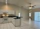 Bright kitchen featuring white appliances, black countertops, and easy access to the living area at 1204 L Pavia Blvd # 1204, Venice, FL 34292