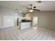 Bright living space featuring white tile flooring, contemporary ceiling fan, and an open concept kitchen at 1204 L Pavia Blvd # 1204, Venice, FL 34292