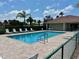Community pool with lounge chairs and clubhouse at 1204 L Pavia Blvd # 1204, Venice, FL 34292