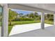 Spacious back patio with a view of the lush, green backyard at 1228 Pineland Ave, Venice, FL 34285