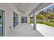 Large back patio featuring ceiling fan, sliding doors and great outdoor views at 1228 Pineland Ave, Venice, FL 34285