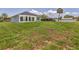 Spacious backyard featuring lush green grass and palm trees at 1228 Pineland Ave, Venice, FL 34285