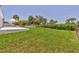 Large, well-maintained backyard with lush green grass and mature trees at 1228 Pineland Ave, Venice, FL 34285