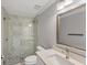 Modern bathroom featuring a glass shower, stone accent wall, and a vanity at 1228 Pineland Ave, Venice, FL 34285
