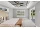 Bright bedroom features a ceiling fan, large windows, neutral decor, and a sliding glass door at 1228 Pineland Ave, Venice, FL 34285