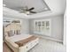 Bright bedroom featuring a trey ceiling, ceiling fan, large windows, and neutral decor at 1228 Pineland Ave, Venice, FL 34285