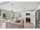 Charming kitchen featuring stainless steel appliances, granite countertops, and backyard views at 1228 Pineland Ave, Venice, FL 34285