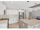Contemporary kitchen with stainless steel appliances, granite countertops, and white cabinetry at 1228 Pineland Ave, Venice, FL 34285