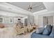 Bright and airy open-concept living room and kitchen with modern seating and stainless steel appliances at 1228 Pineland Ave, Venice, FL 34285