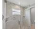 Elegant shower stall featuring a glass door, natural light, and a mosaic tile floor at 1228 Pineland Ave, Venice, FL 34285
