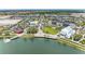Beautiful aerial view of a community with modern buildings and a scenic lakefront at 12390 Wellen Golf St # 203, Venice, FL 34293