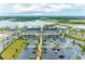 Aerial view of the community featuring modern buildings, parking lots, and beautiful landscaping at 12390 Wellen Golf St # 203, Venice, FL 34293