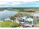 Aerial view of the community featuring a large lake, recreational amenities, and various commercial spaces at 12390 Wellen Golf St # 203, Venice, FL 34293