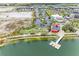 Scenic aerial view of lakefront property with dock and surrounding community amenities at 12390 Wellen Golf St # 203, Venice, FL 34293