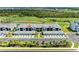 Stunning aerial view of condo with a golf course, lush landscaping and private parking at 12390 Wellen Golf St # 203, Venice, FL 34293