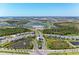 An aerial view of a Primary-planned community featuring lakes, golf course, and modern residences at 12390 Wellen Golf St # 203, Venice, FL 34293