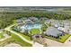 Stunning aerial view of resort-style amenities including tennis courts, pools, and community clubhouse at 12390 Wellen Golf St # 203, Venice, FL 34293