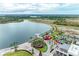 Scenic aerial view showcasing a lakefront community with recreational areas, green spaces, and commercial buildings at 12390 Wellen Golf St # 203, Venice, FL 34293