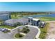 Stunning aerial view of community buildings and golf course with serene lake in the background at 12390 Wellen Golf St # 203, Venice, FL 34293
