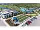 Extensive aerial view showcases the pool, bocce ball, clubhouse, golf course, and parking in the community at 12390 Wellen Golf St # 203, Venice, FL 34293