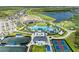 Beautiful aerial view of community amenities featuring pools, tennis courts, and clubhouse at 12390 Wellen Golf St # 203, Venice, FL 34293