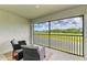 Relaxing screened balcony with comfortable wicker chairs and scenic golf course views at 12390 Wellen Golf St # 203, Venice, FL 34293