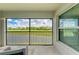 Spacious screened balcony with views of the golf course and lake, featuring a comfortable seating area at 12390 Wellen Golf St # 203, Venice, FL 34293