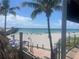 Scenic beach view with a pier, clear skies, and relaxing beachfront seating at 12390 Wellen Golf St # 203, Venice, FL 34293