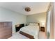 Bedroom features a ceiling fan, side tables with lamps, and a large window at 12390 Wellen Golf St # 203, Venice, FL 34293