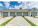 Four-car garage with paved driveway and lush landscaping for added curb appeal at 12390 Wellen Golf St # 203, Venice, FL 34293