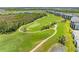 Scenic aerial view of the lush, well-maintained golf course near residences at 12390 Wellen Golf St # 203, Venice, FL 34293
