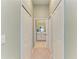 Hallway with ample closet space leading to the bathroom with a dual vanity at 12390 Wellen Golf St # 203, Venice, FL 34293