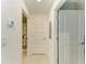 Hallway with tile floor leading to bathroom with shower and decorative curtain at 12390 Wellen Golf St # 203, Venice, FL 34293