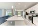 Bright and airy kitchen featuring stainless steel appliances, white cabinets, and an eat-in island at 12390 Wellen Golf St # 203, Venice, FL 34293