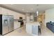The kitchen includes stainless steel appliances, a large island, and white cabinets at 12390 Wellen Golf St # 203, Venice, FL 34293