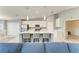 A modern kitchen with stainless steel appliances, white cabinets, and a large center island with bar seating at 12390 Wellen Golf St # 203, Venice, FL 34293