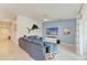 Comfortable living room with blue sectional sofa and tile flooring at 12390 Wellen Golf St # 203, Venice, FL 34293