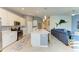 Open-concept living area featuring a modern kitchen with an island and an adjacent living room at 12390 Wellen Golf St # 203, Venice, FL 34293