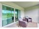 Relaxing screened patio with comfortable seating and picturesque golf course views at 12390 Wellen Golf St # 203, Venice, FL 34293