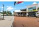 Outdoor seating at a stylish restaurant with brick pathway and clear skies at 12390 Wellen Golf St # 203, Venice, FL 34293