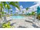 Relaxing pool with lounge chairs, umbrellas, and lush landscaping, offering a perfect oasis for residents at 12390 Wellen Golf St # 203, Venice, FL 34293