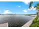 Picturesque lake view with dock and lush greenery, creating a serene setting at 12390 Wellen Golf St # 203, Venice, FL 34293
