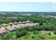 Aerial shot of a community showing the neighborhood with mature trees and tile roofs at 12871 Cinqueterre Dr, Venice, FL 34293