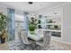 Elegant dining room features modern chandelier, mirror accent, and seating for six at 12871 Cinqueterre Dr, Venice, FL 34293