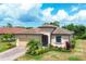 Charming single-story home featuring a tile roof and meticulously manicured landscaping at 12871 Cinqueterre Dr, Venice, FL 34293