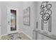 Elegant foyer features a decorative glass door and contemporary artwork at 12871 Cinqueterre Dr, Venice, FL 34293